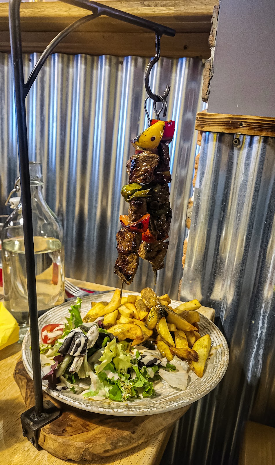Steak shish kabobs, fries, and salad,